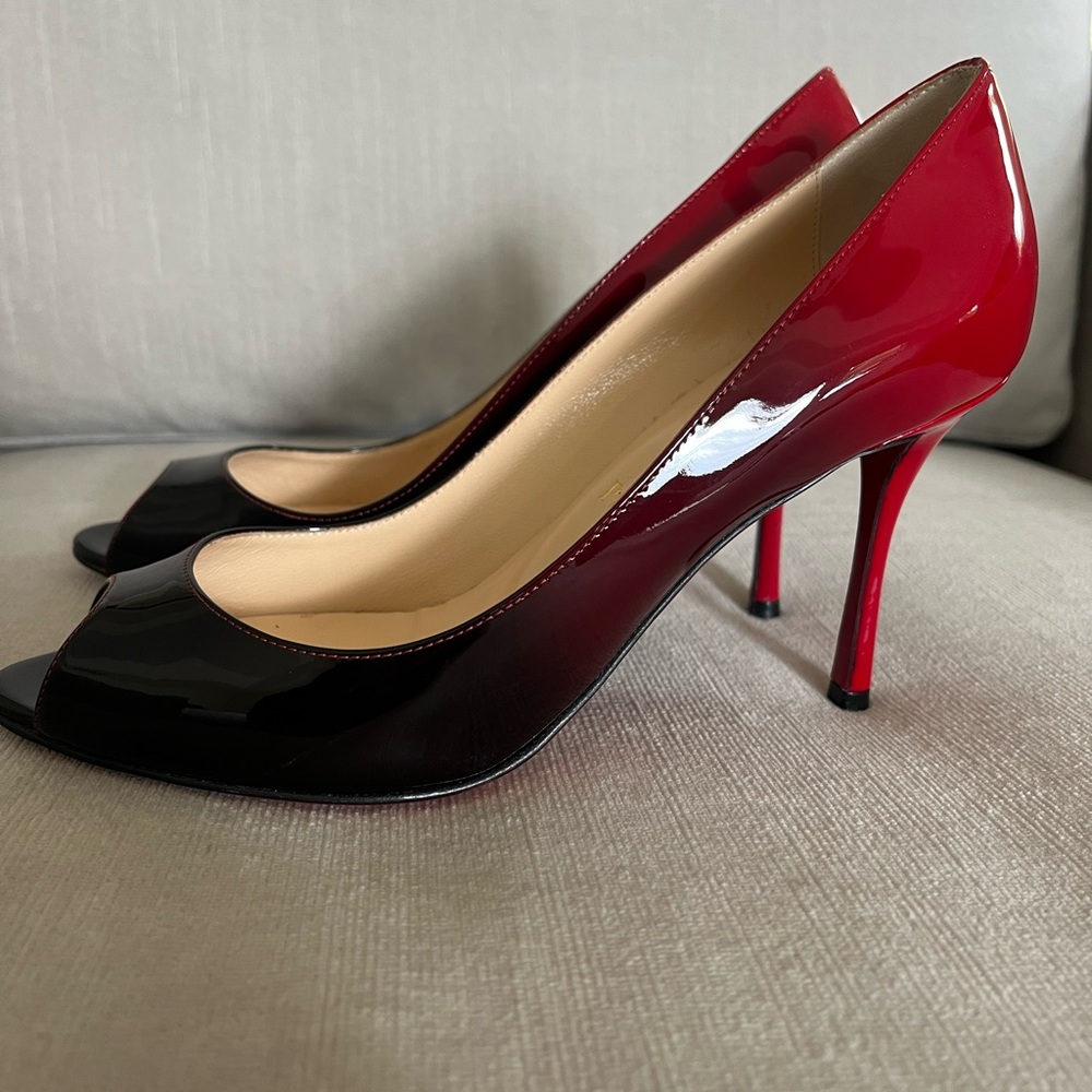 Striking Louboutin Red and Black High Heels with Peep-Toe Design